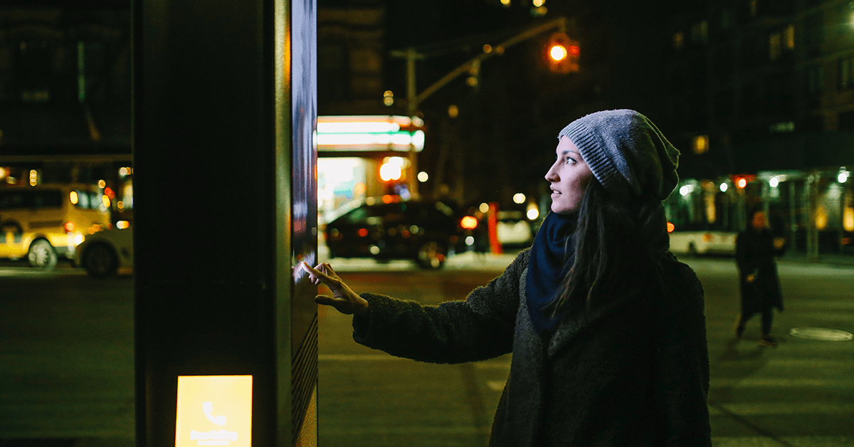 A woman touching an interactive digital screen