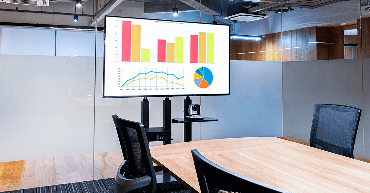 A digital signage screen displaying graphs in an office environment