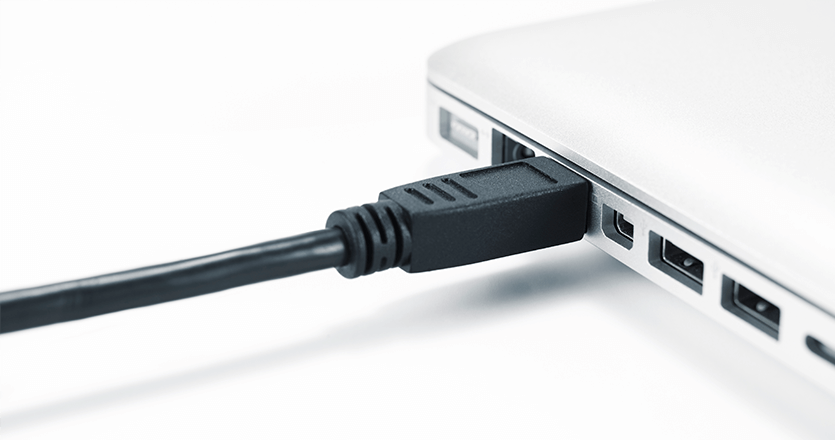 An image of a laptop port connected to cable 