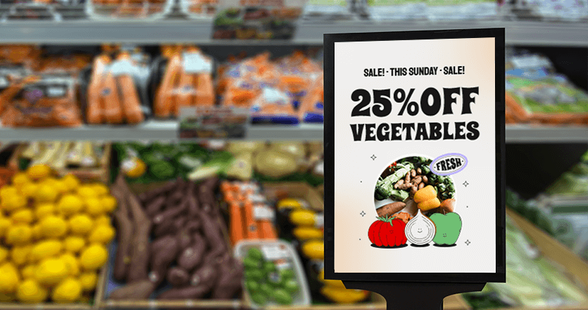 A digital display in a grocery store promoting a sale on vegetables