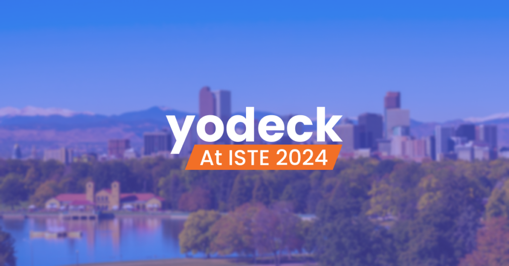 An image of a cityscape with the phrase "Yodeck at ISTE 2024" displayed prominently in the foreground.