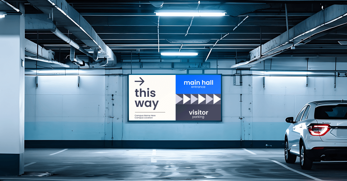 An underground parking with a big digital signage screen showing the right way