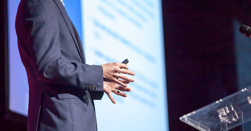 Man in conference event presenting using digital signag screen